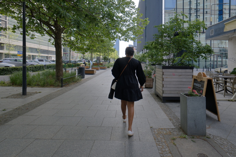 Person wearing a black tiered long-sleeve mini dress going